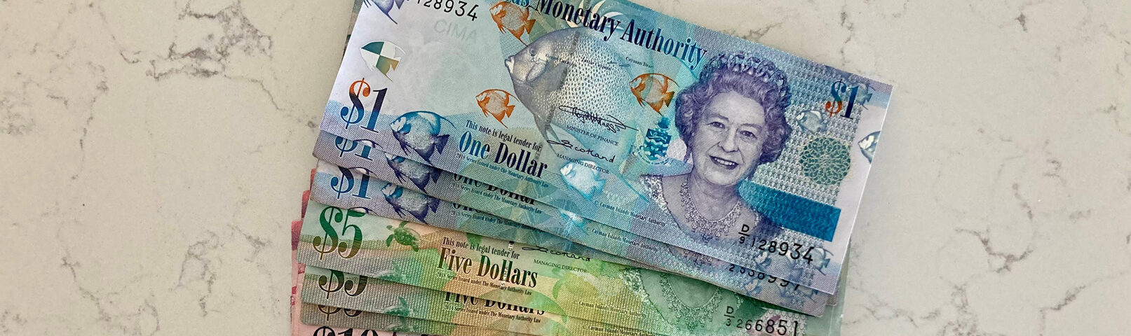 Neatly Stacked Cayman Islands banknotes featuring Queen Elizabeth II